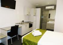 View of Queen studio kitchenette and bathroom